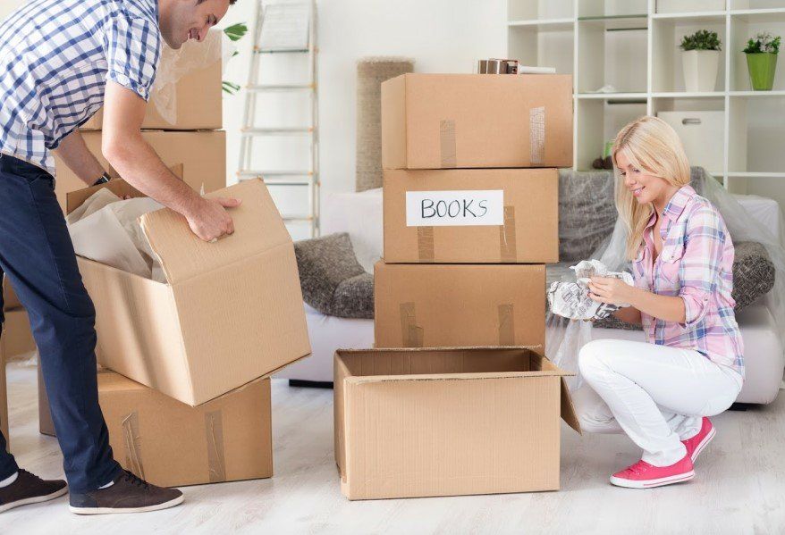 Couple Decluttering Items — Jacksonville, FL — Helping Hands Movers, Inc.