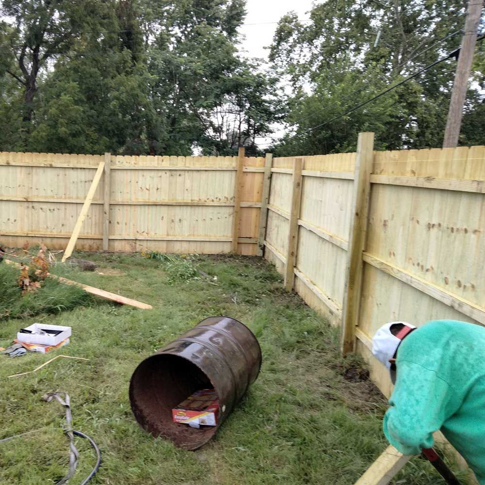 Man Checking the Fence — Caseyville, IL — Two Brothers Tree Service and Landscape