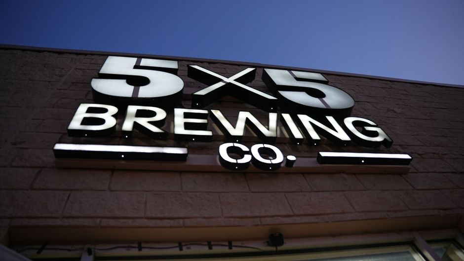 A sign for 5x5 brewing co. is lit up