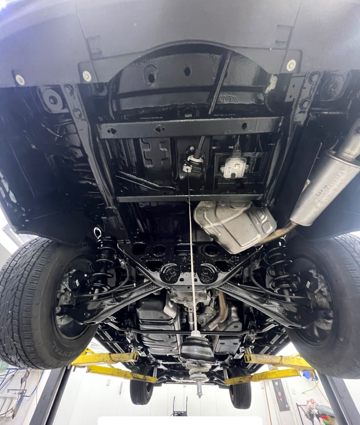 professional wool wax undercoating and rustproofing on vehicle undercarriage in Rochester Minnesota