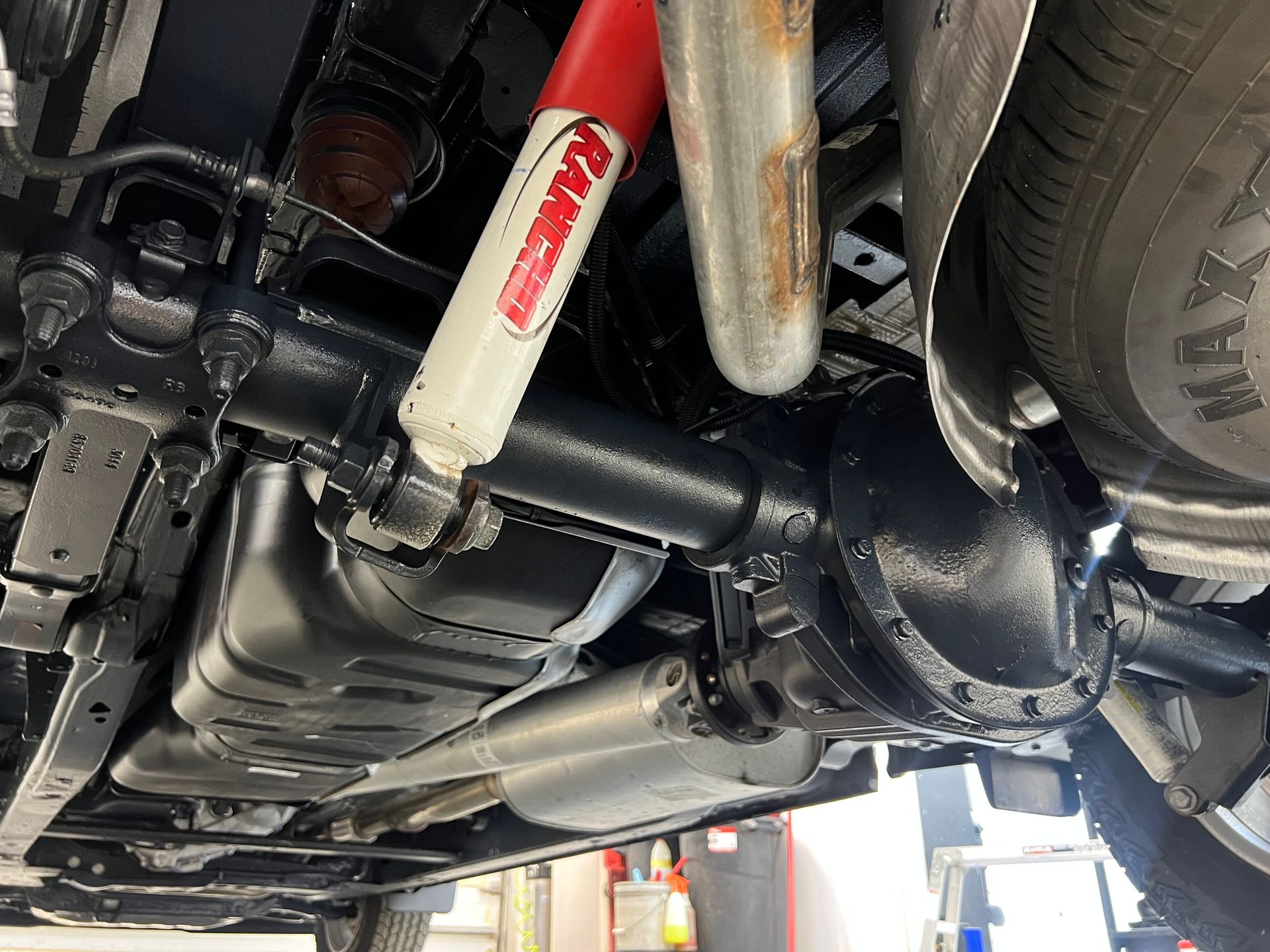 A close up of the underside of a car with a shock absorber.