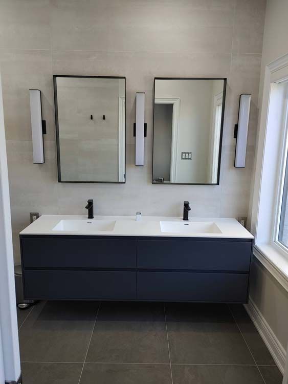 A bathroom with two sinks and two mirrors