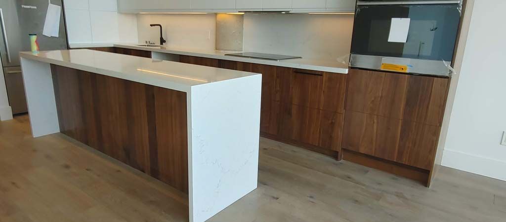 A kitchen with wooden cabinets and a white counter top.