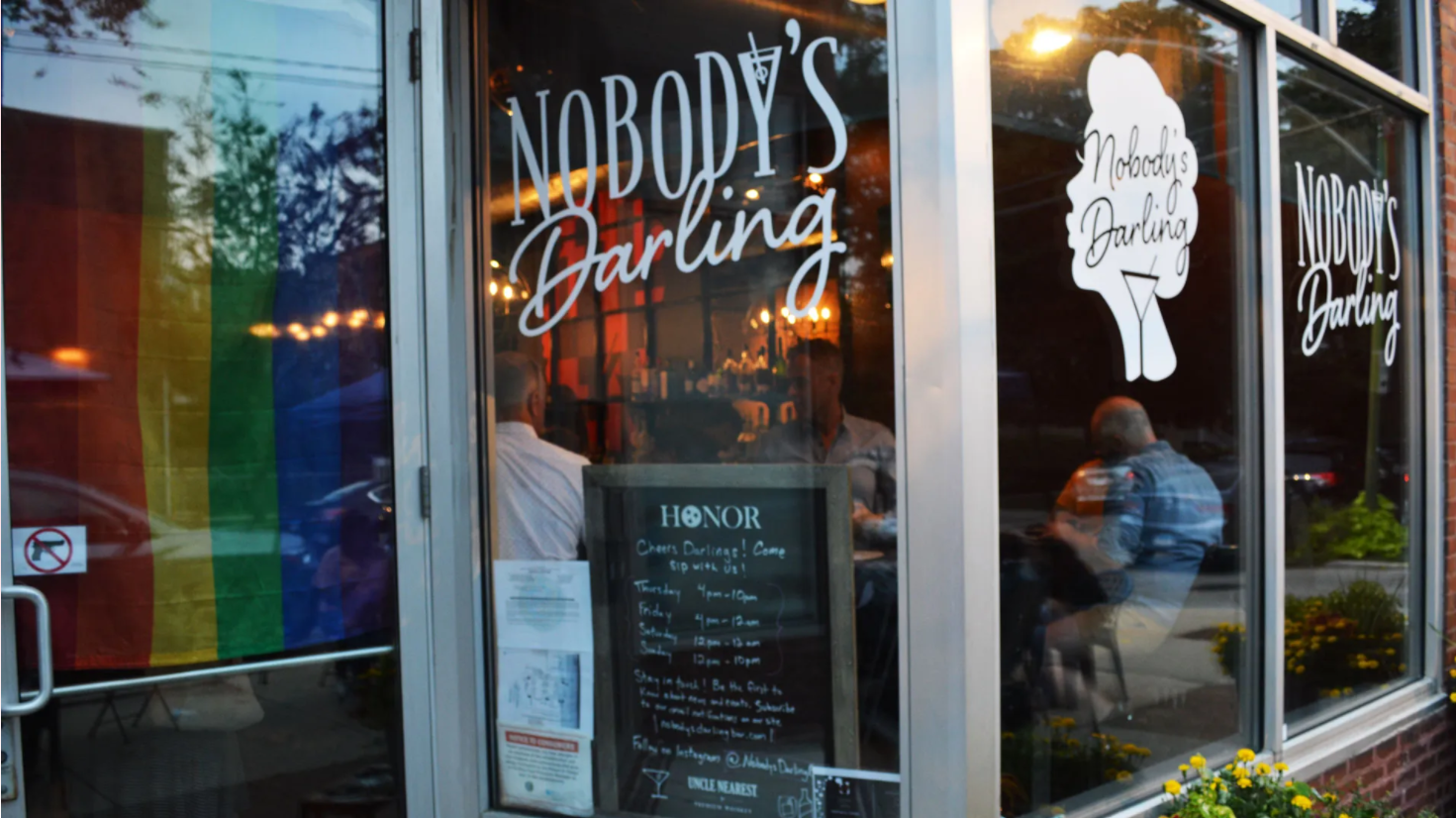 A nobody 's darling restaurant with a rainbow flag in the window