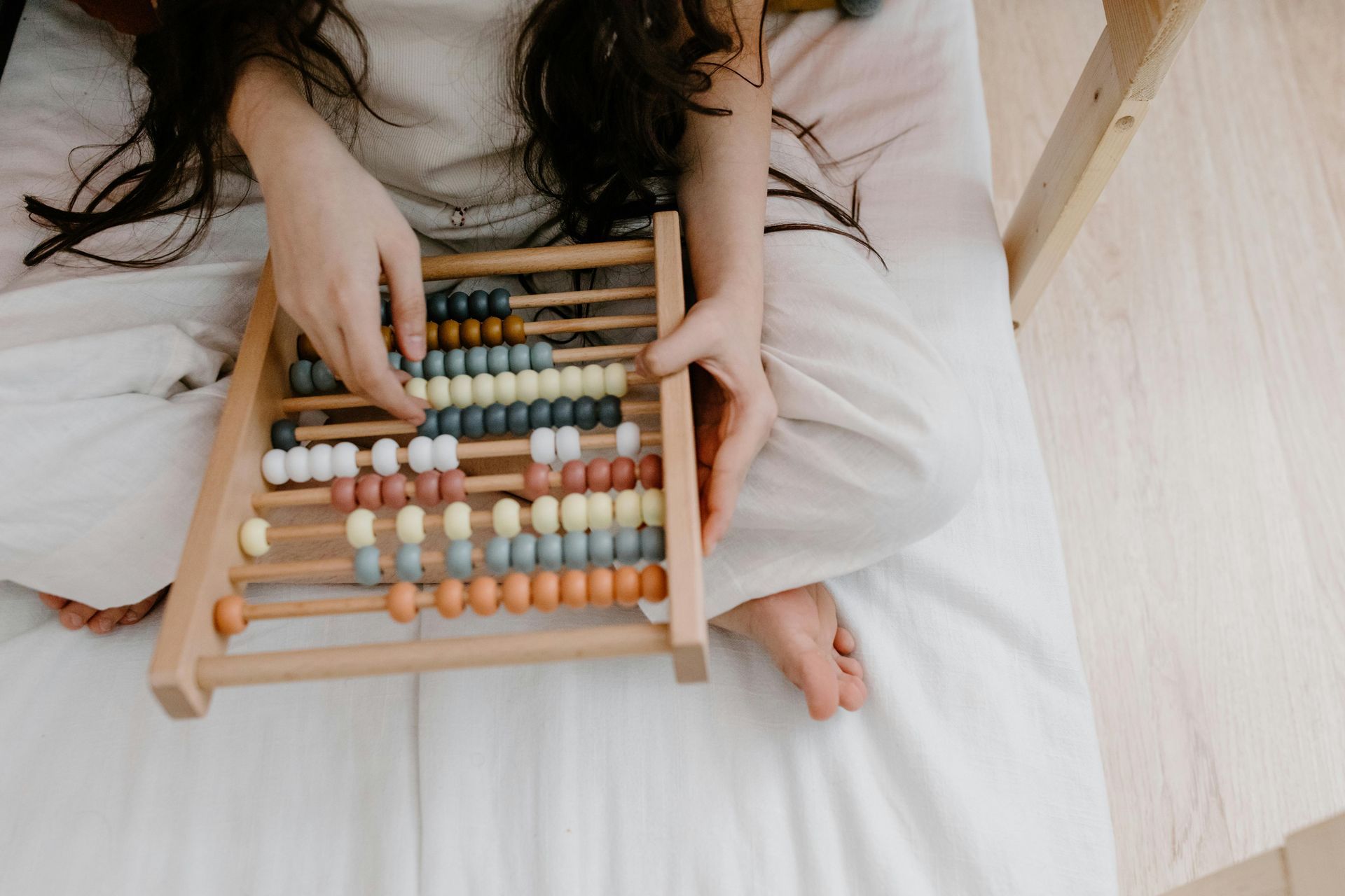 woman sitting and playing with an abacus