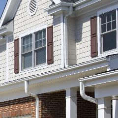 a house with a porch and a lot of windows