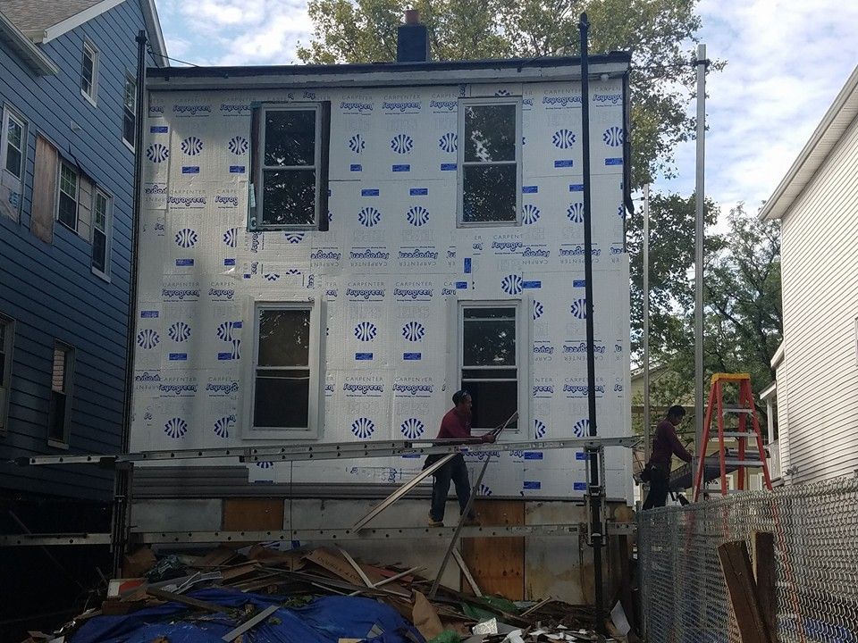 a house is being remodeled with a ladder in the foreground