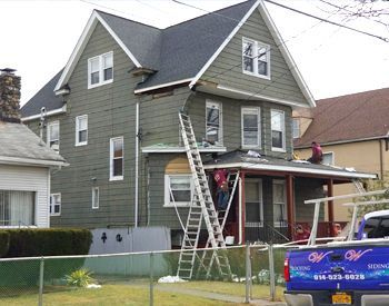 a group of men are working on a roof .