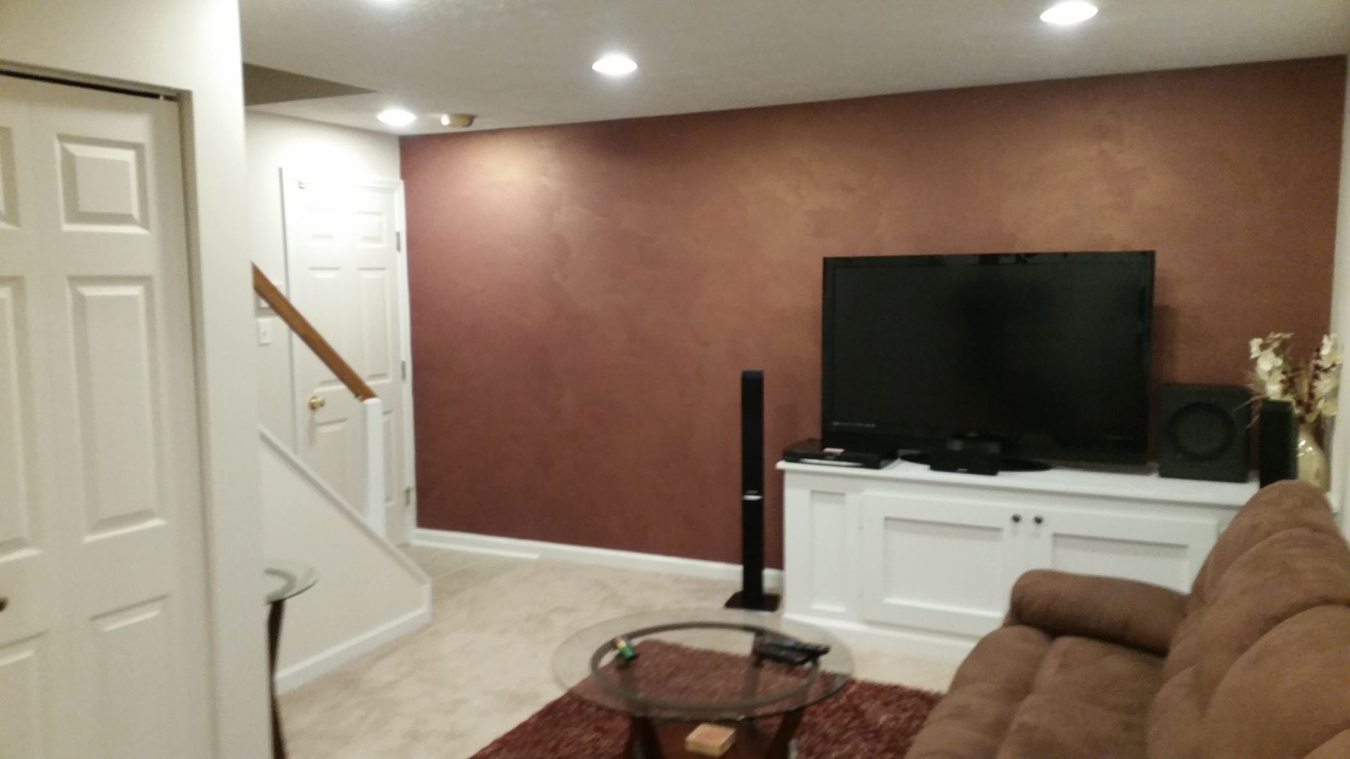 A living room with a couch and a flat screen tv