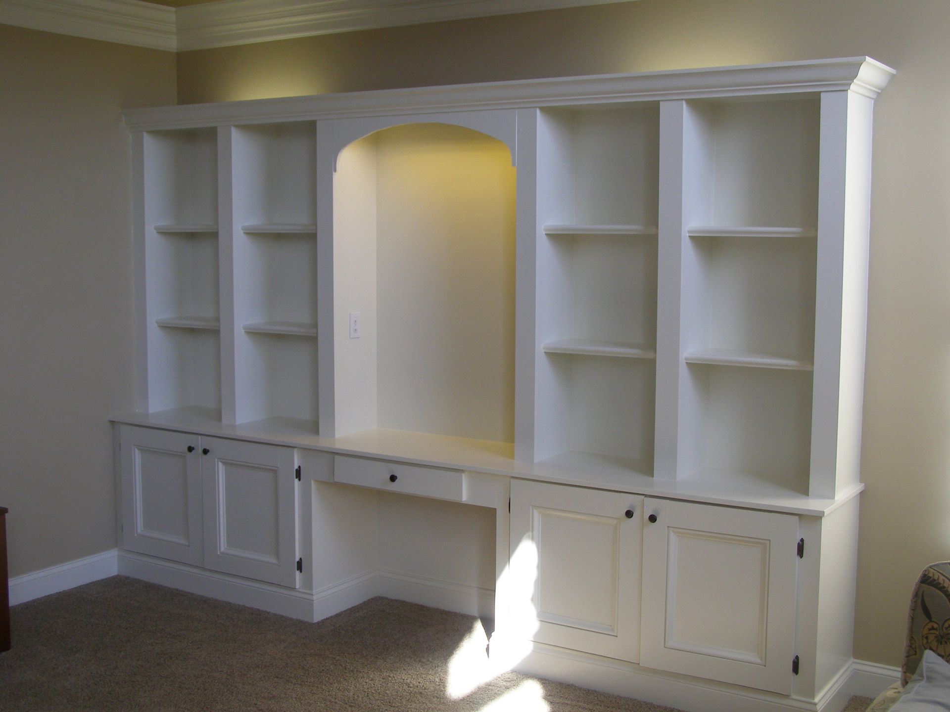 A room with a lot of shelves and cabinets