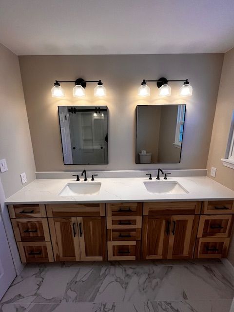 A bathroom with two sinks and two mirrors.