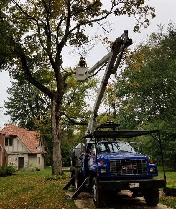 A blue gmc truck is parked in front of a house