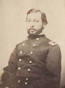 A black and white photo of a man in a military uniform.