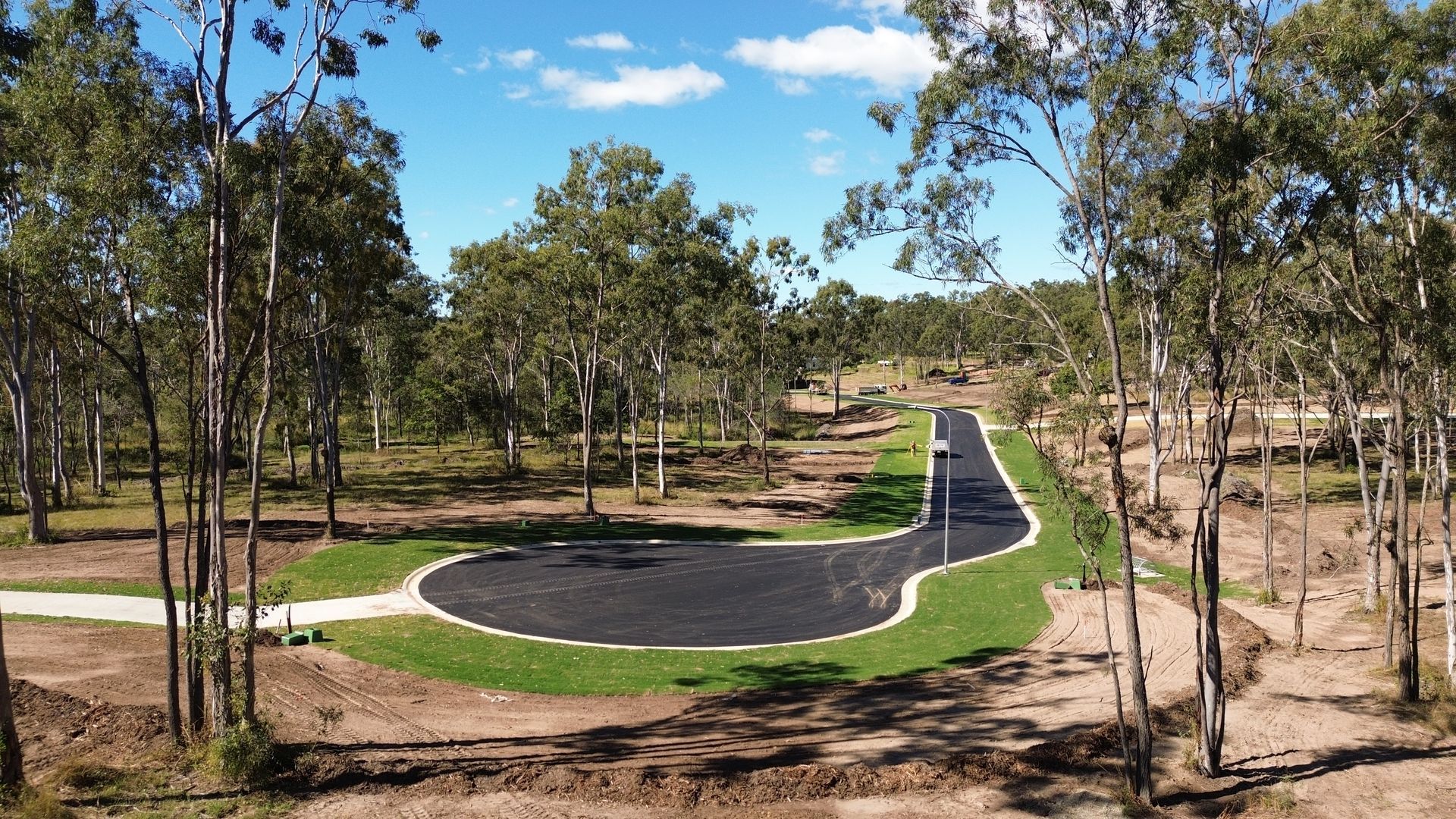An aerial view of a road in the middle of a forest