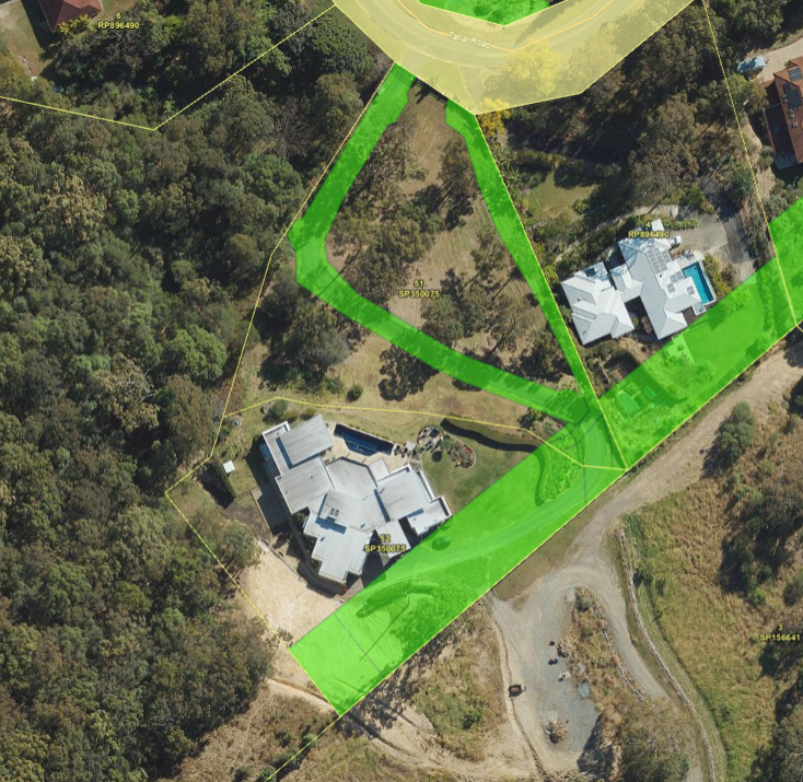 An aerial view of a house in the middle of a forest