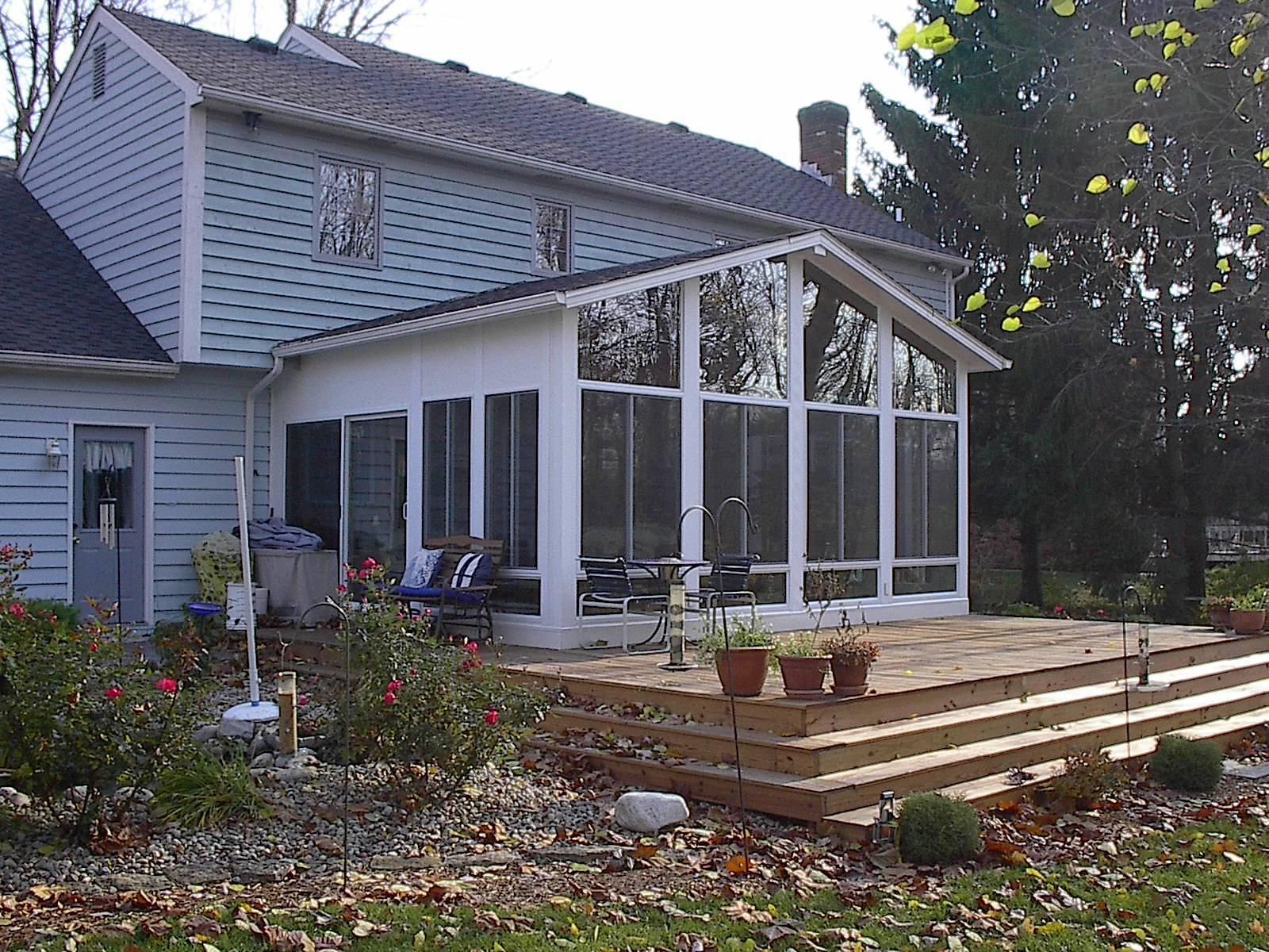 A house with a screened in porch and a deck