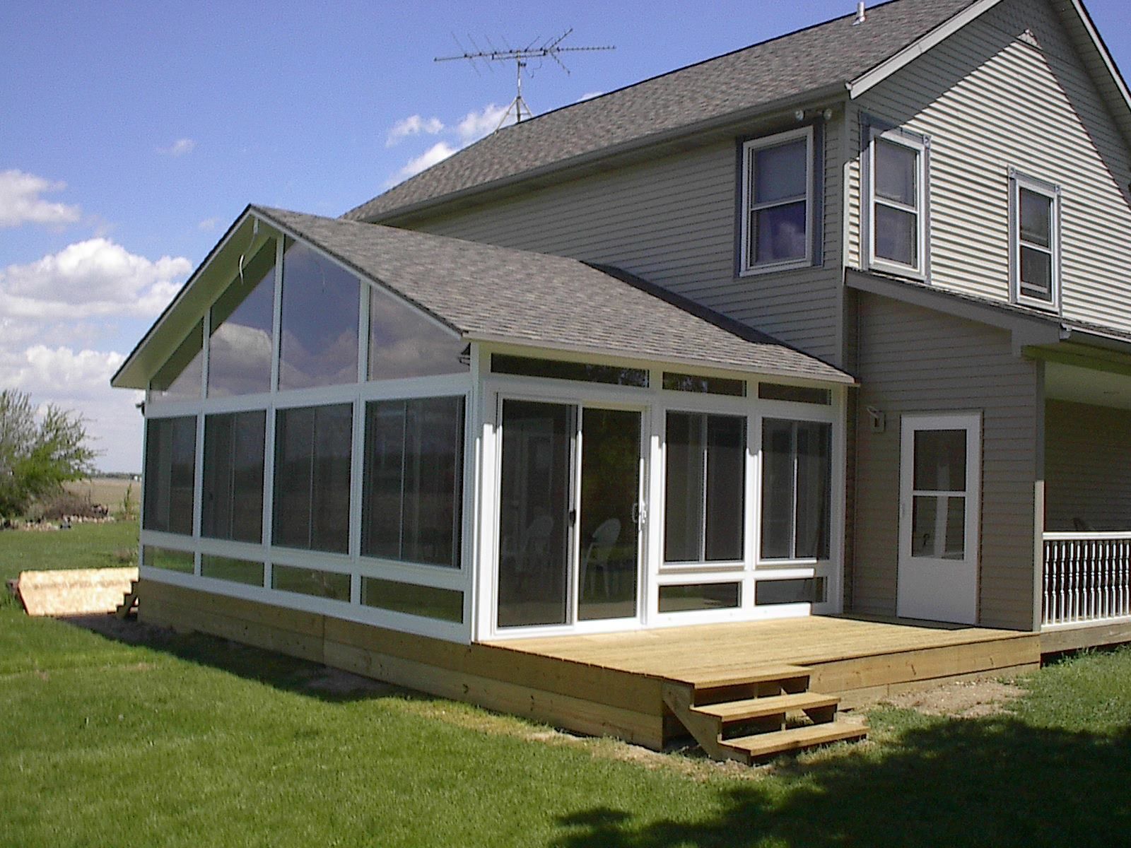 A house with a screened in porch and stairs