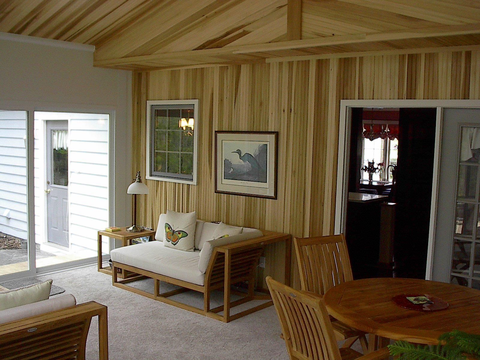A living room with wood paneling and a couch