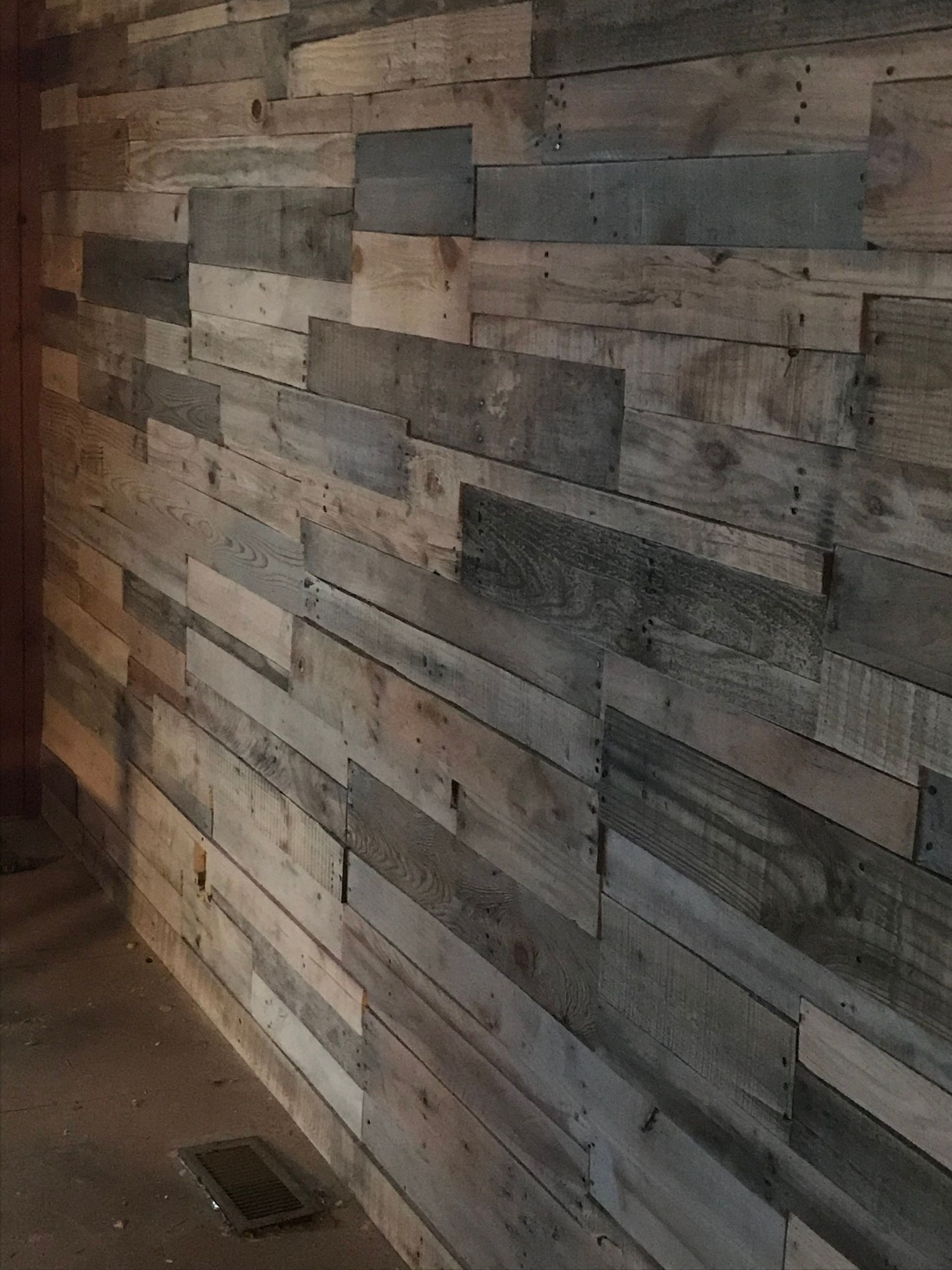 Rustic wood plank wall, varying shades of brown and gray.