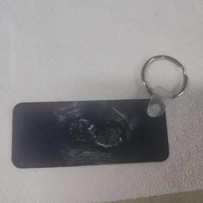 A black keychain is sitting on top of a white towel.