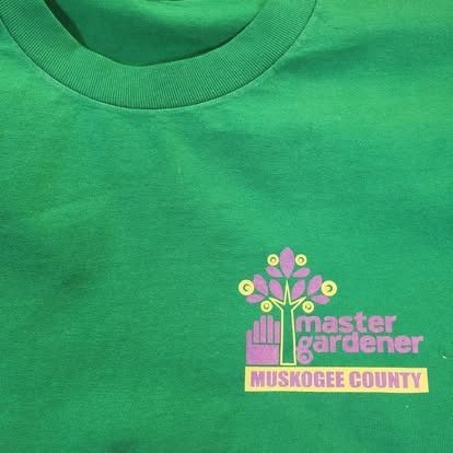 A green shirt with a master gardener logo on it