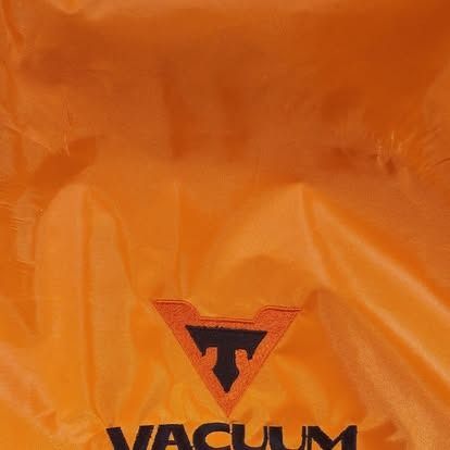 A close up of an orange bag that says vacuum on it