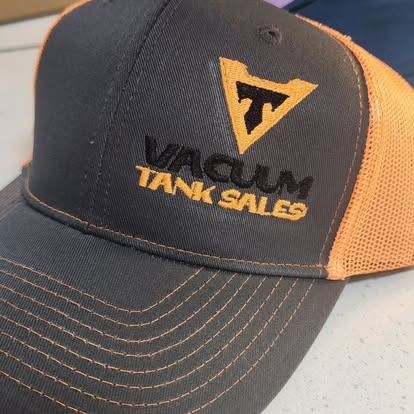 A hat that says vacuum tank sales on it