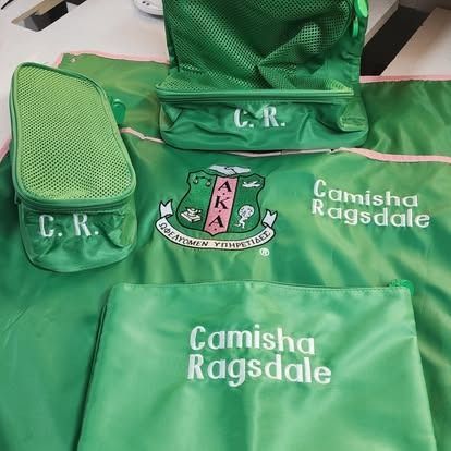 A group of green bags sitting on top of each other on a table.