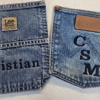 A pair of jeans with the name christian written on them