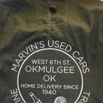 A black jacket with the words marvin 's used cars on it