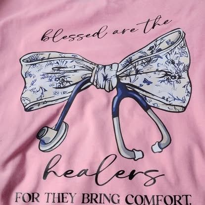 A pink shirt that says blessed are the healers for they bring comfort
