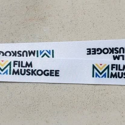 A white ribbon with the words film muskogee on it