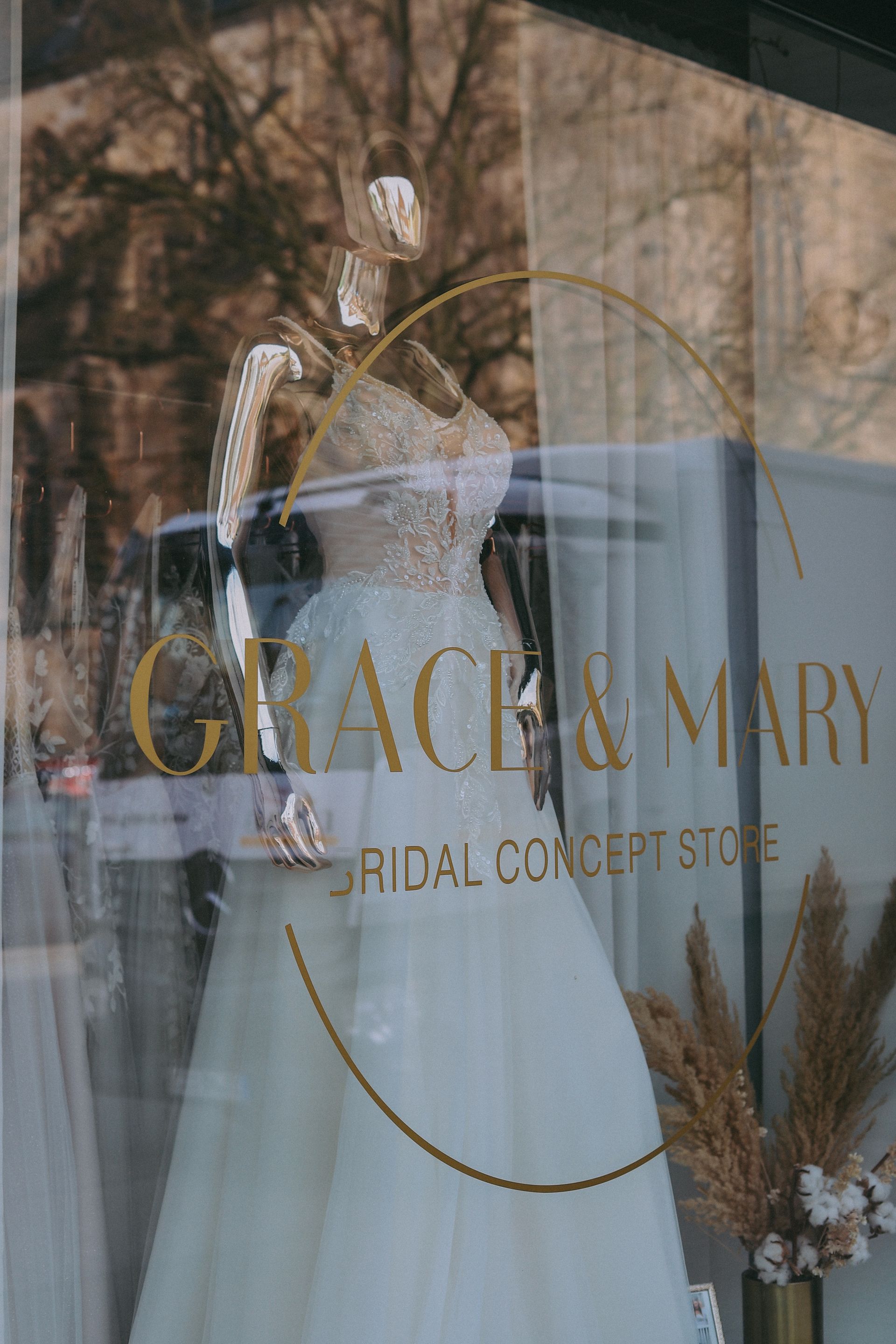 In einem Schaufenster wird ein Brautkleid ausgestellt.