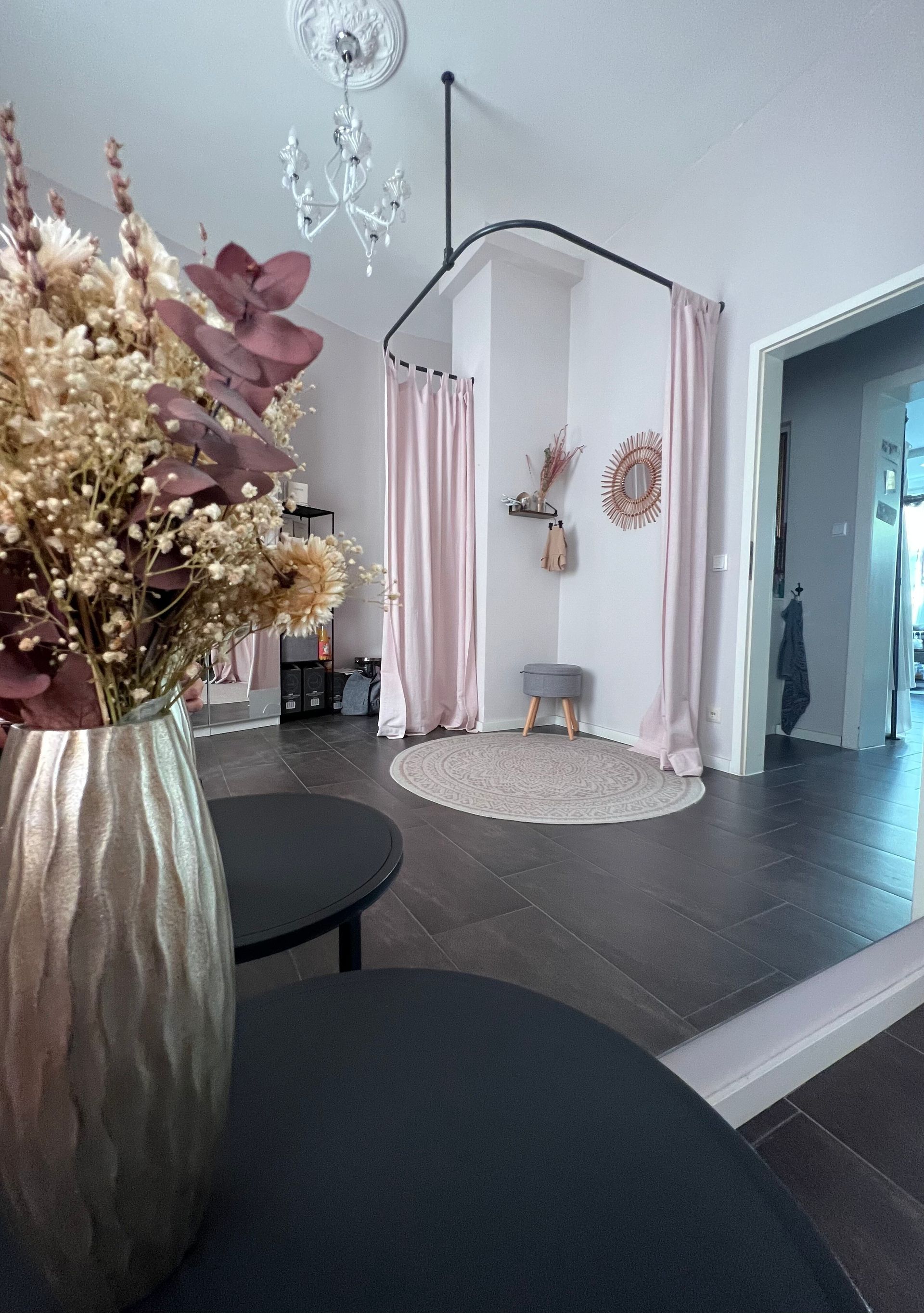 Eine Vase mit Blumen steht auf einem Tisch in einem Zimmer.