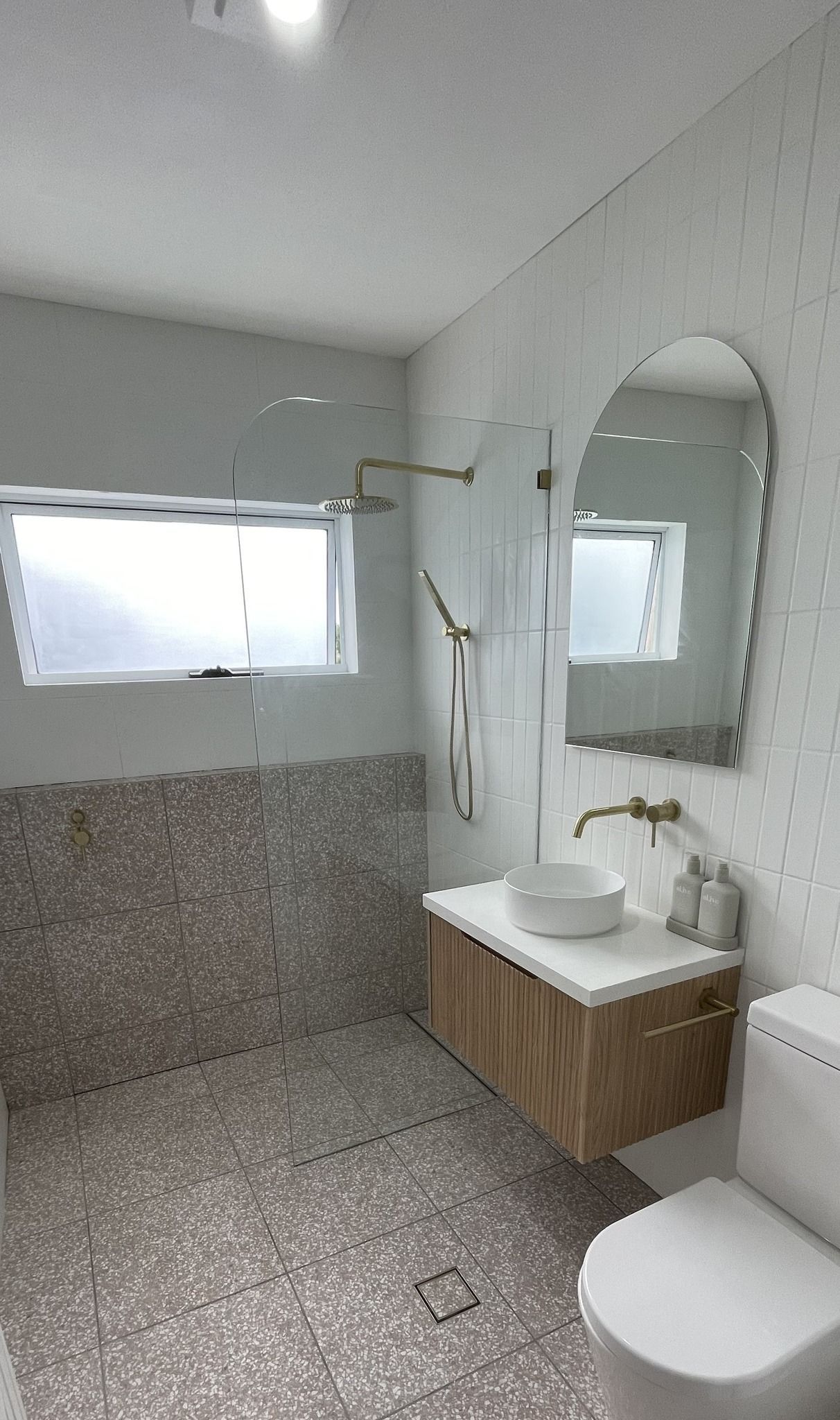 A Bathroom With a Toilet , Sink and Mirror — Bathurst Bathroom Solutions In Eglinton, NSW
