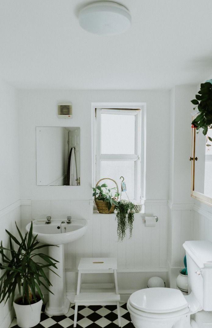 A Bathroom With a Toilet, Sink, and Mirror  — Bathurst Bathroom Solutions In Eglinton, NSW