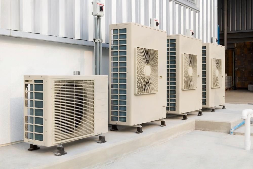 An HVAC technician performing routine maintenance on a commercial generator.