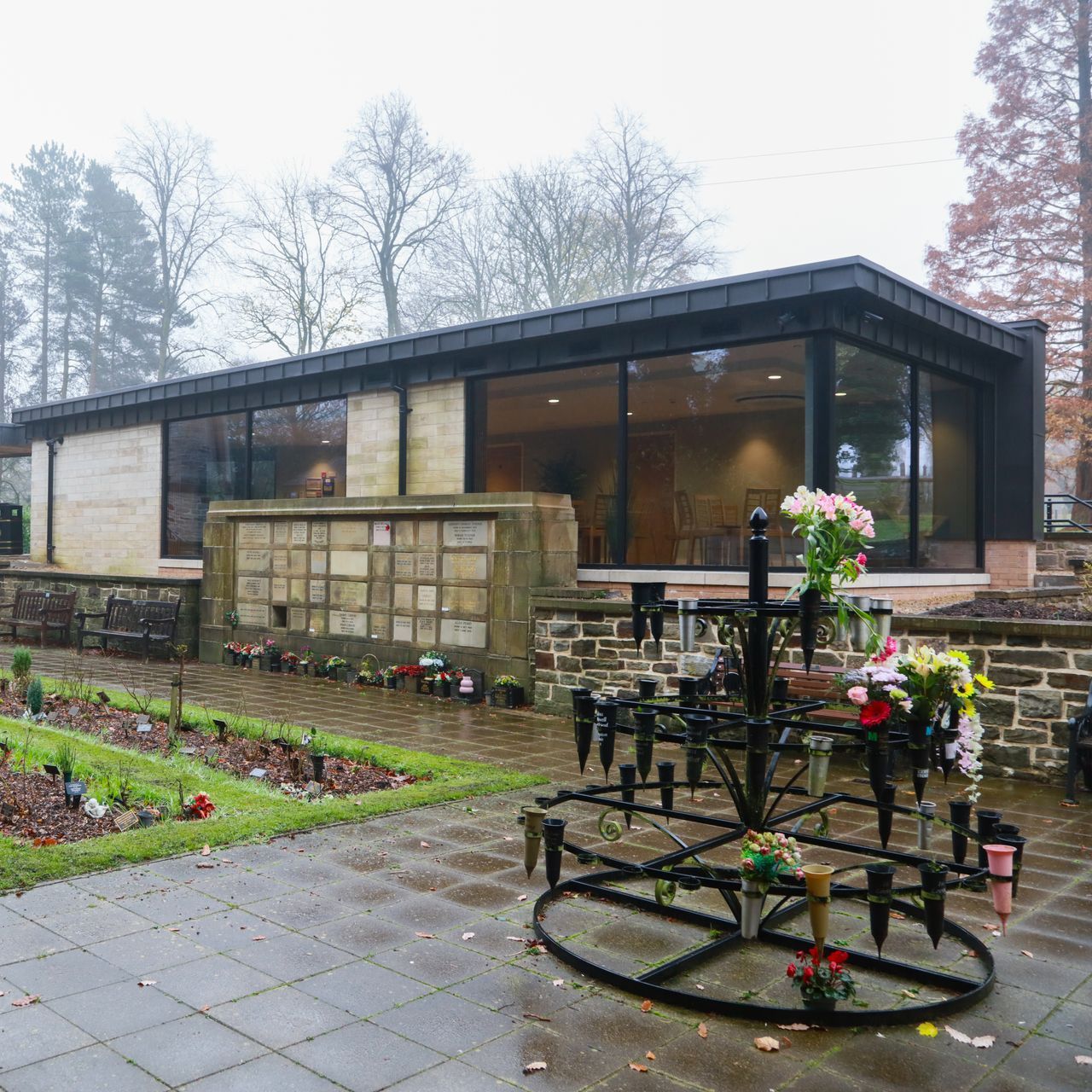 A building with a lot of windows and flowers in front of it