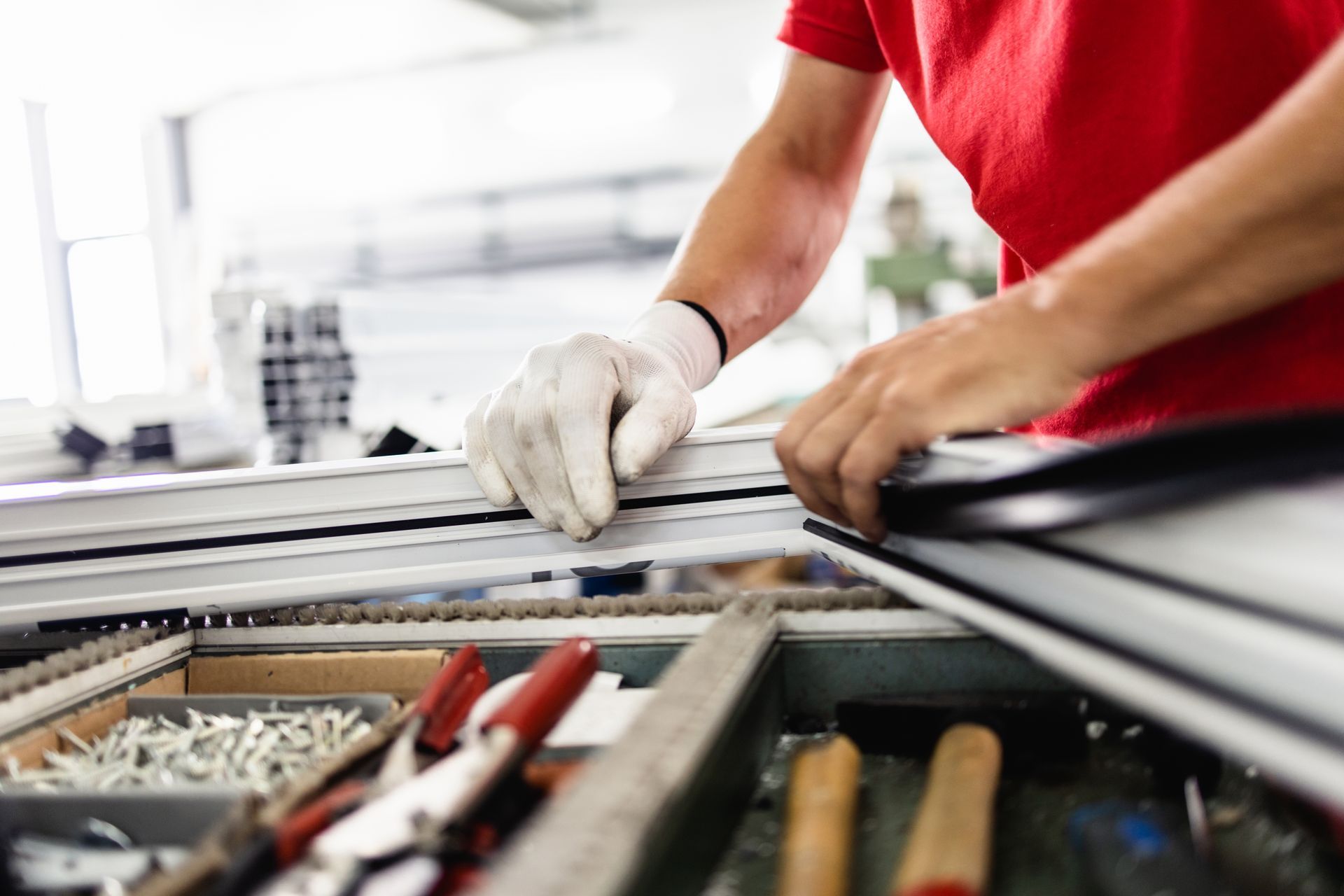 A man is working on a piece of metal in a factory.