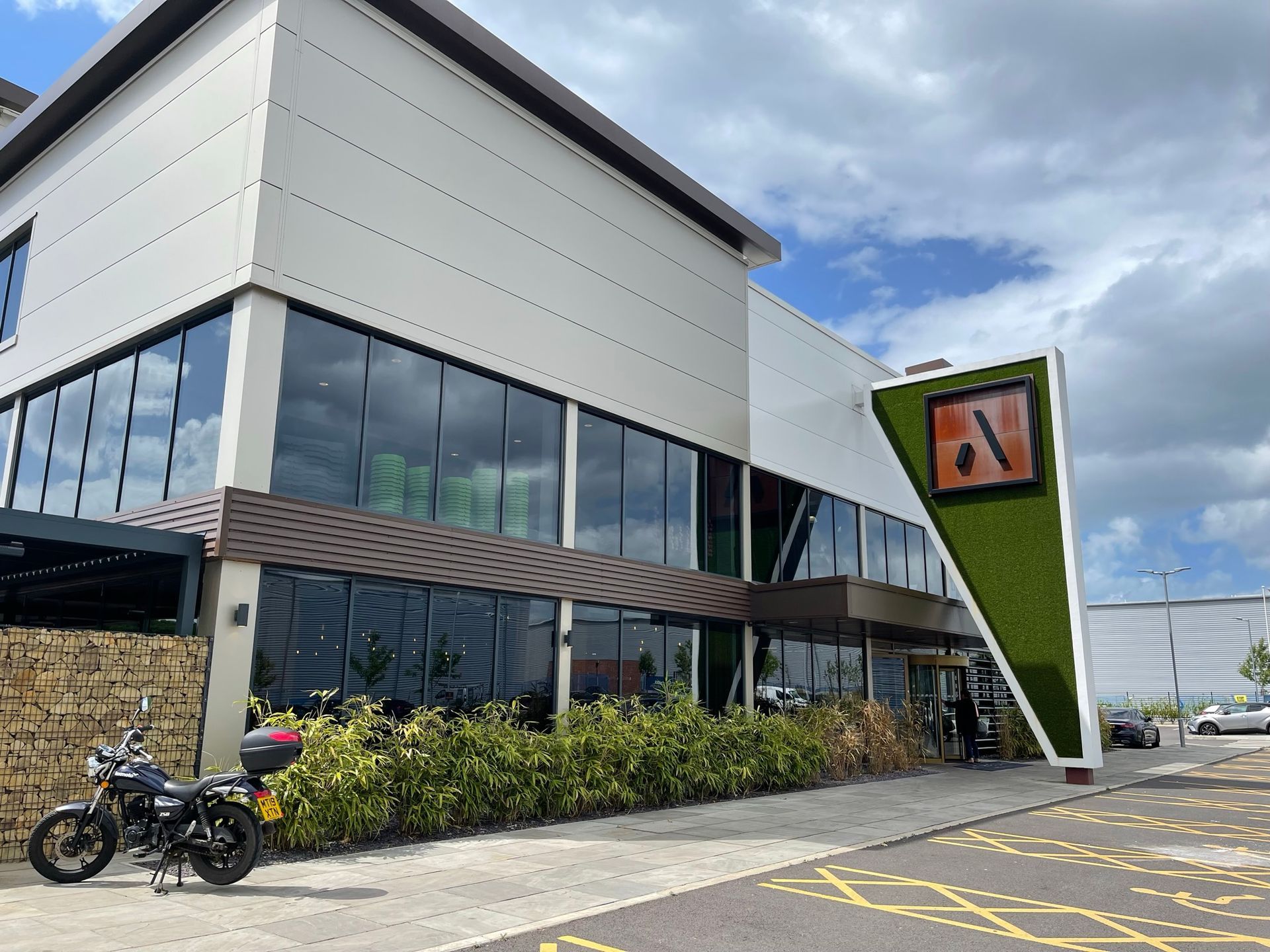 A motorcycle is parked in front of a large building.