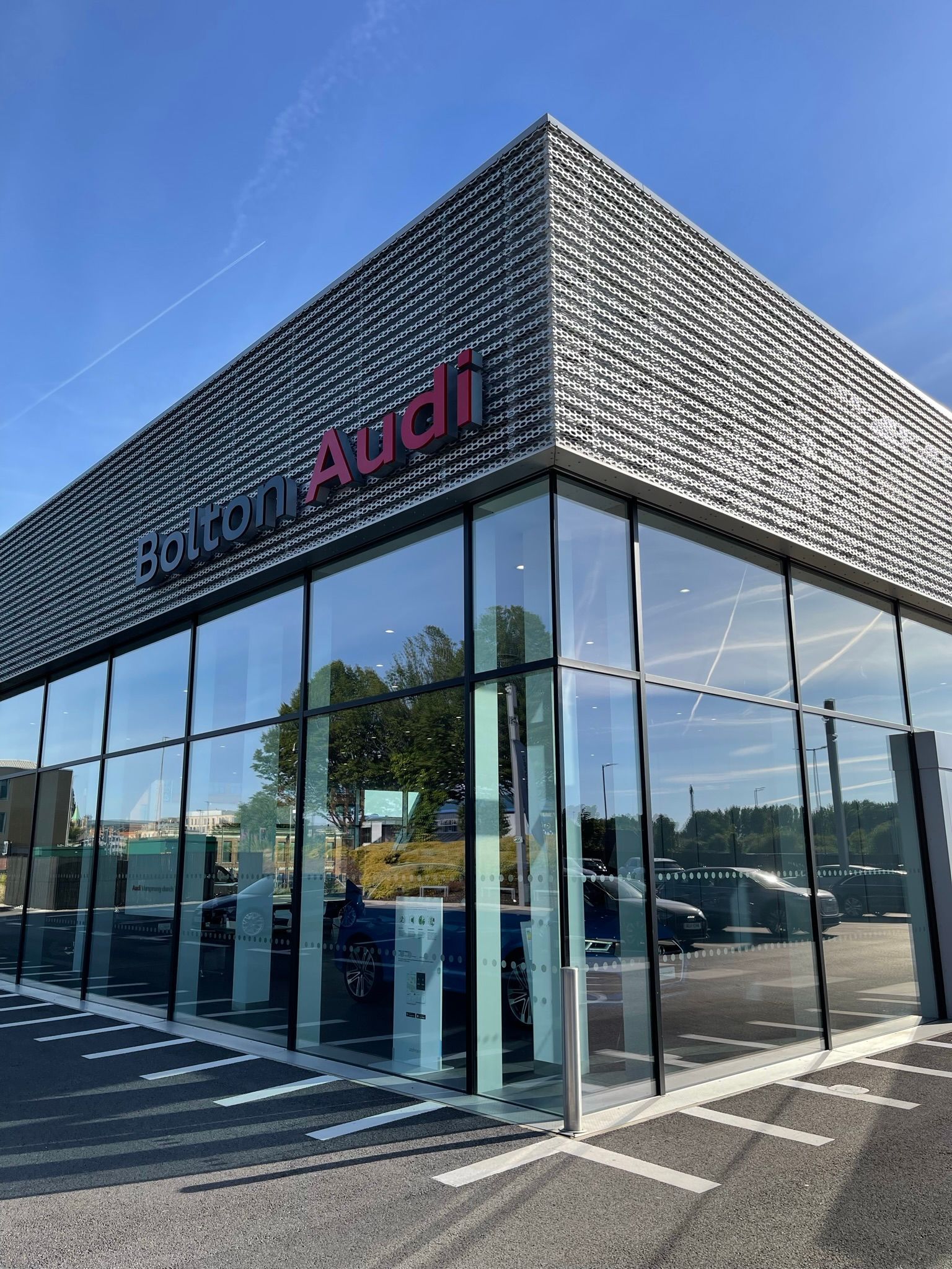 A large glass building with the word audi on it