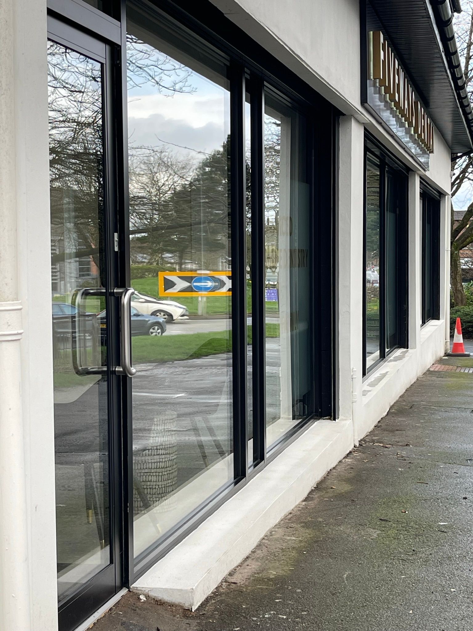 A building with a lot of windows and a black door.