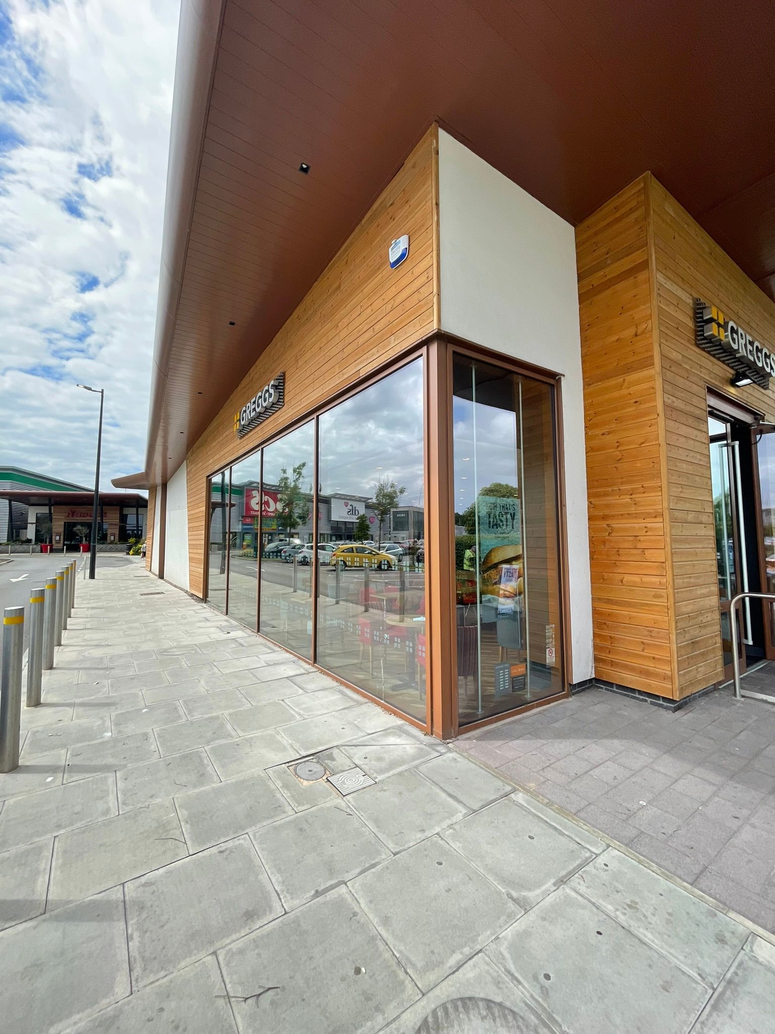 A large building with a lot of windows and a wooden facade.