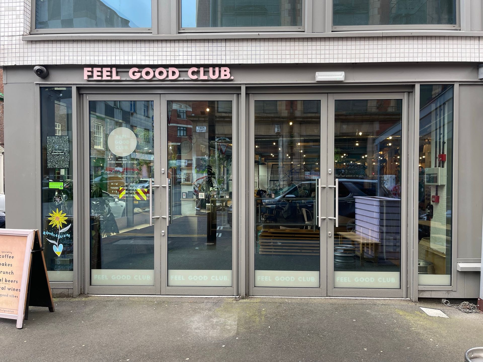 A store front with a sign that says feel good club