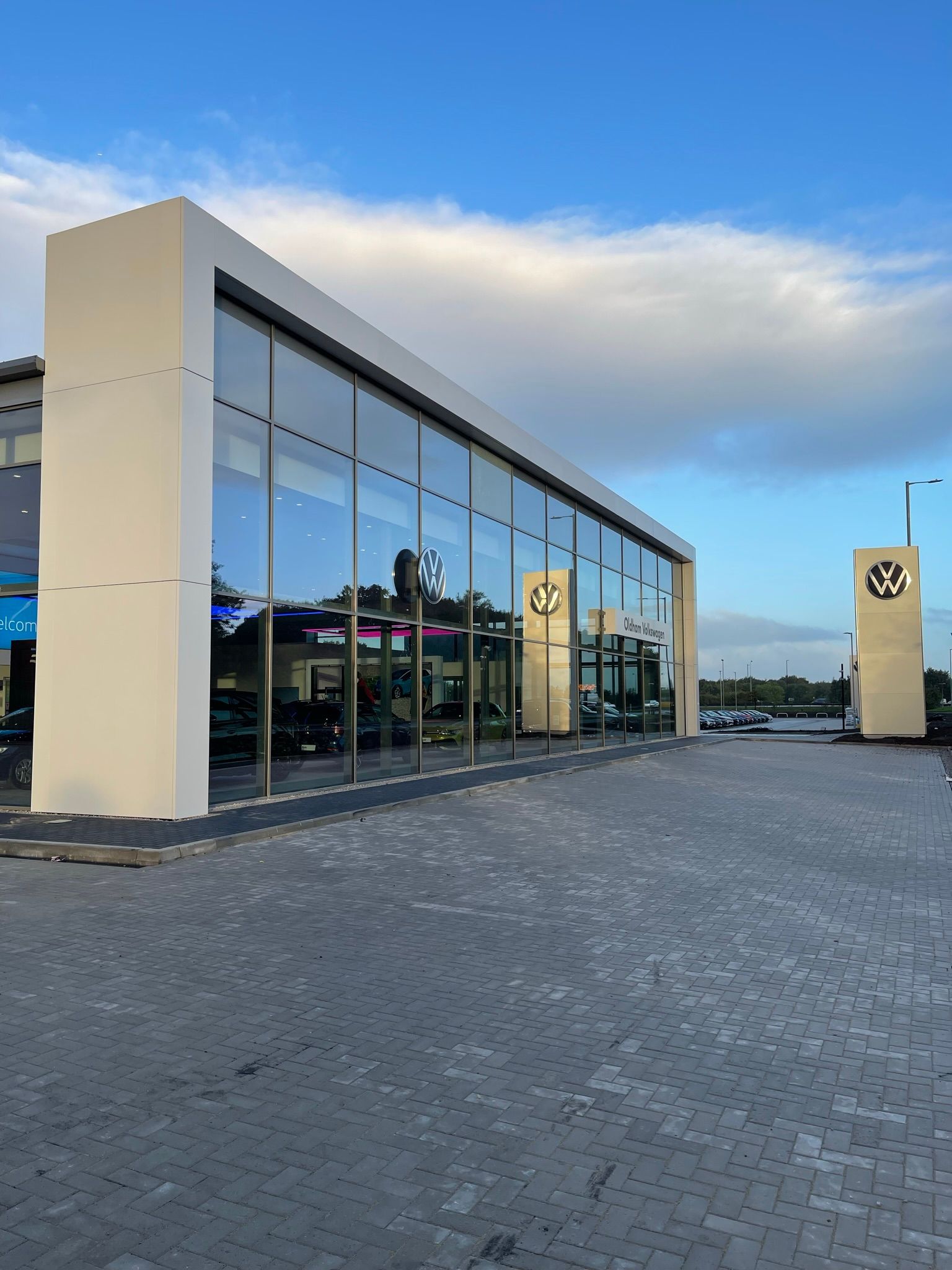 A large building with a lot of windows and cars parked in front of it