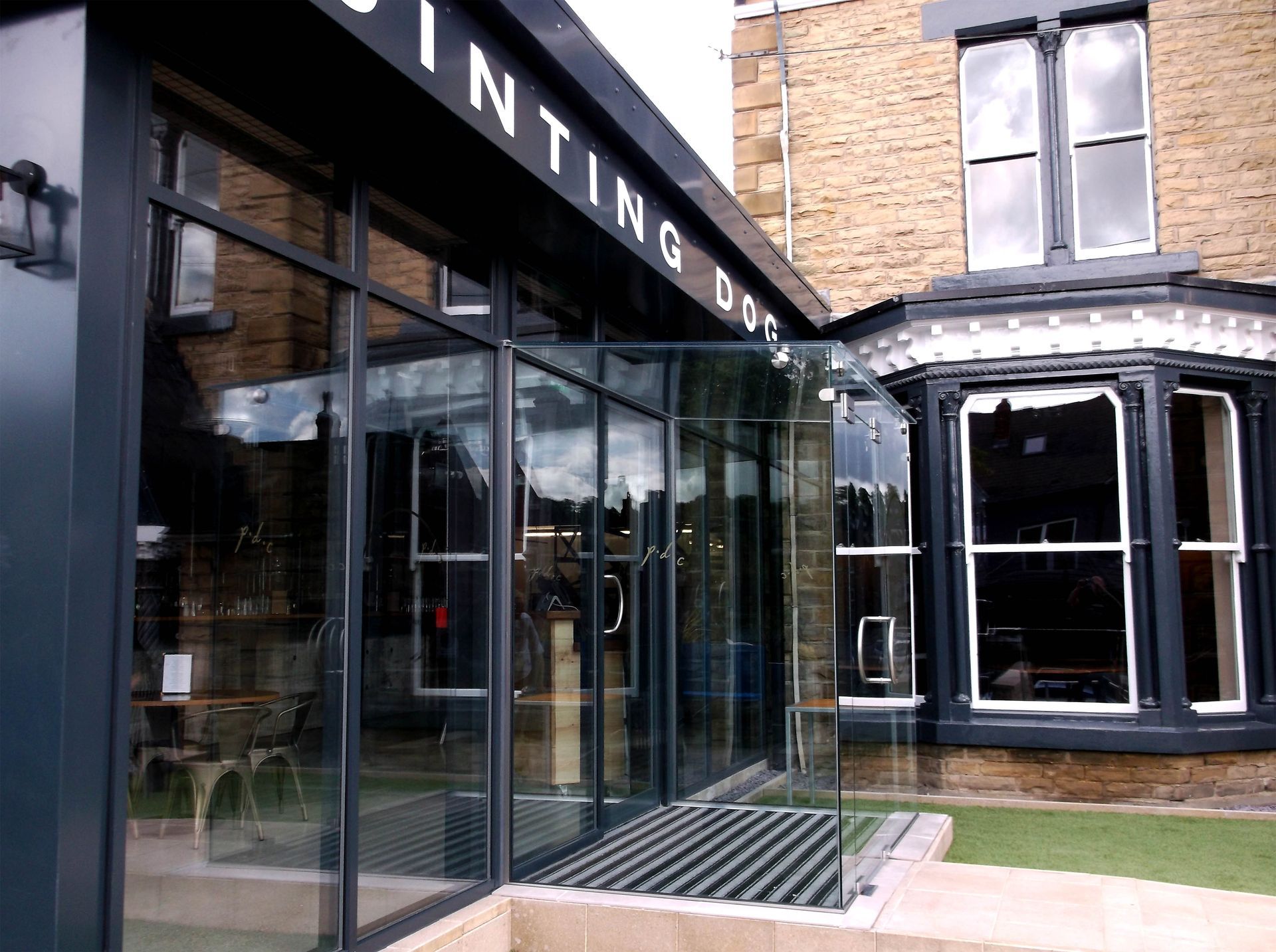 A building with a lot of windows and a sign that says ' painting dog ' on it