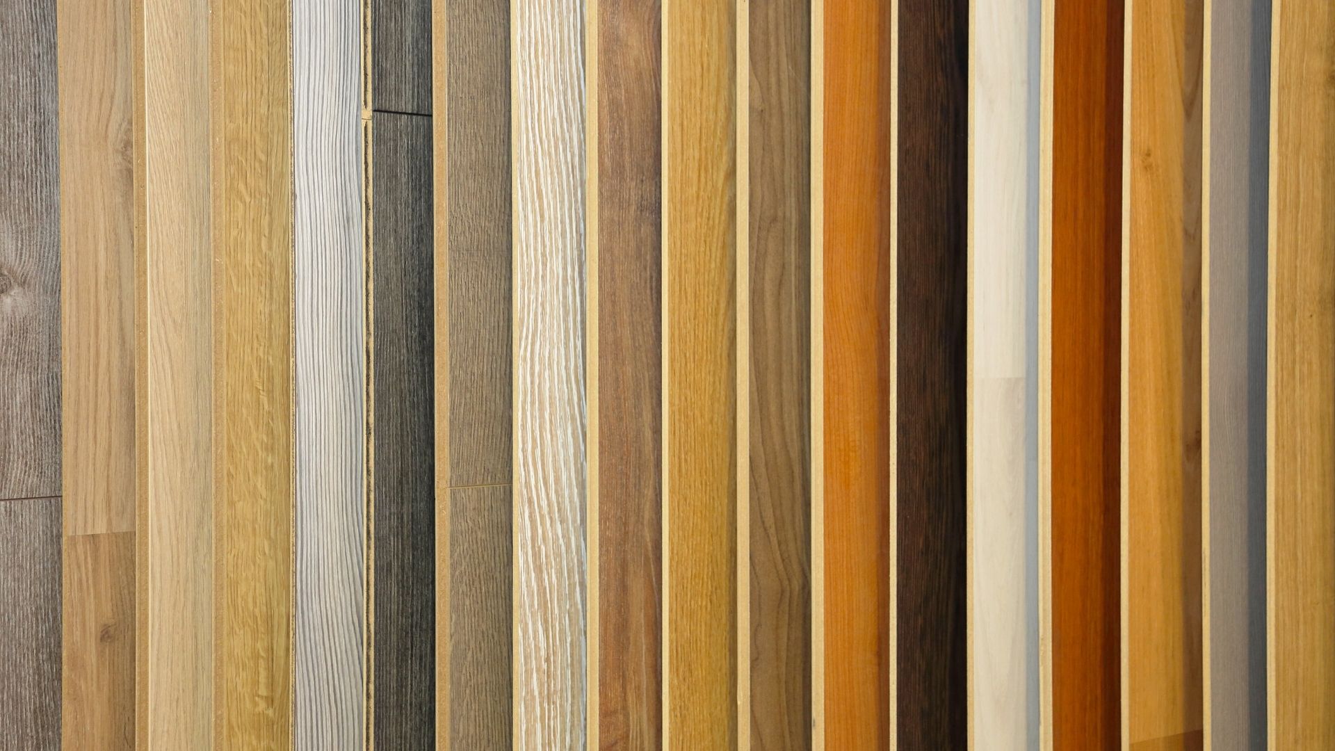Wooden floorboard samples in various colors arranged vertically.