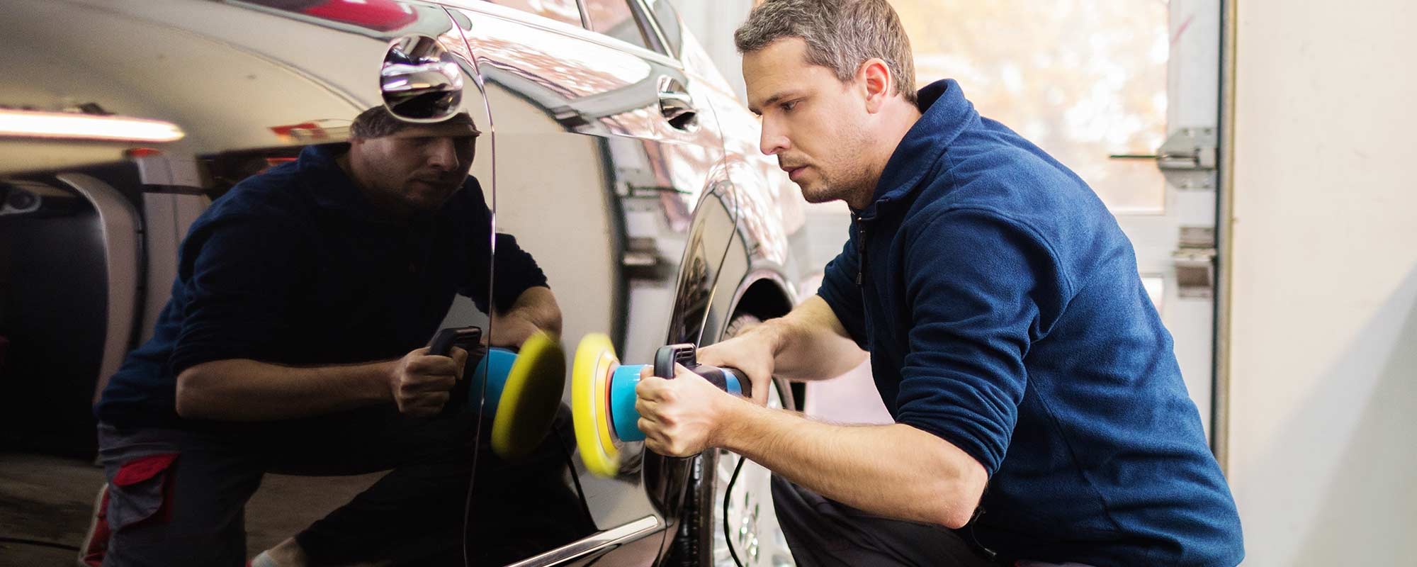 Professional giving last touches to the automobile 