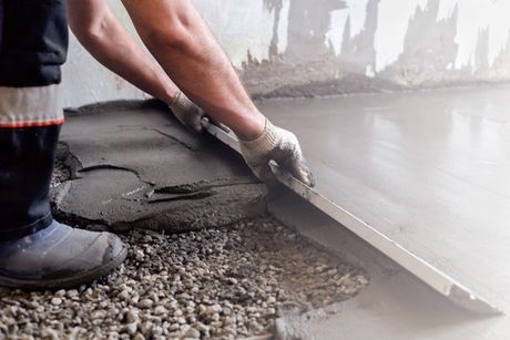 Worker Levels a Floor Cement — Sebastopol, CA — Gus Golobe Paving