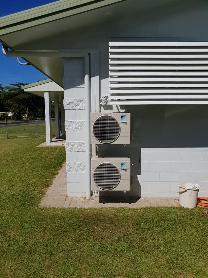 Person Working on Electrical Panel Outdoors, Wires, Breakers, and Meter Visible — Ionspark Electrical in Atherton, QLD